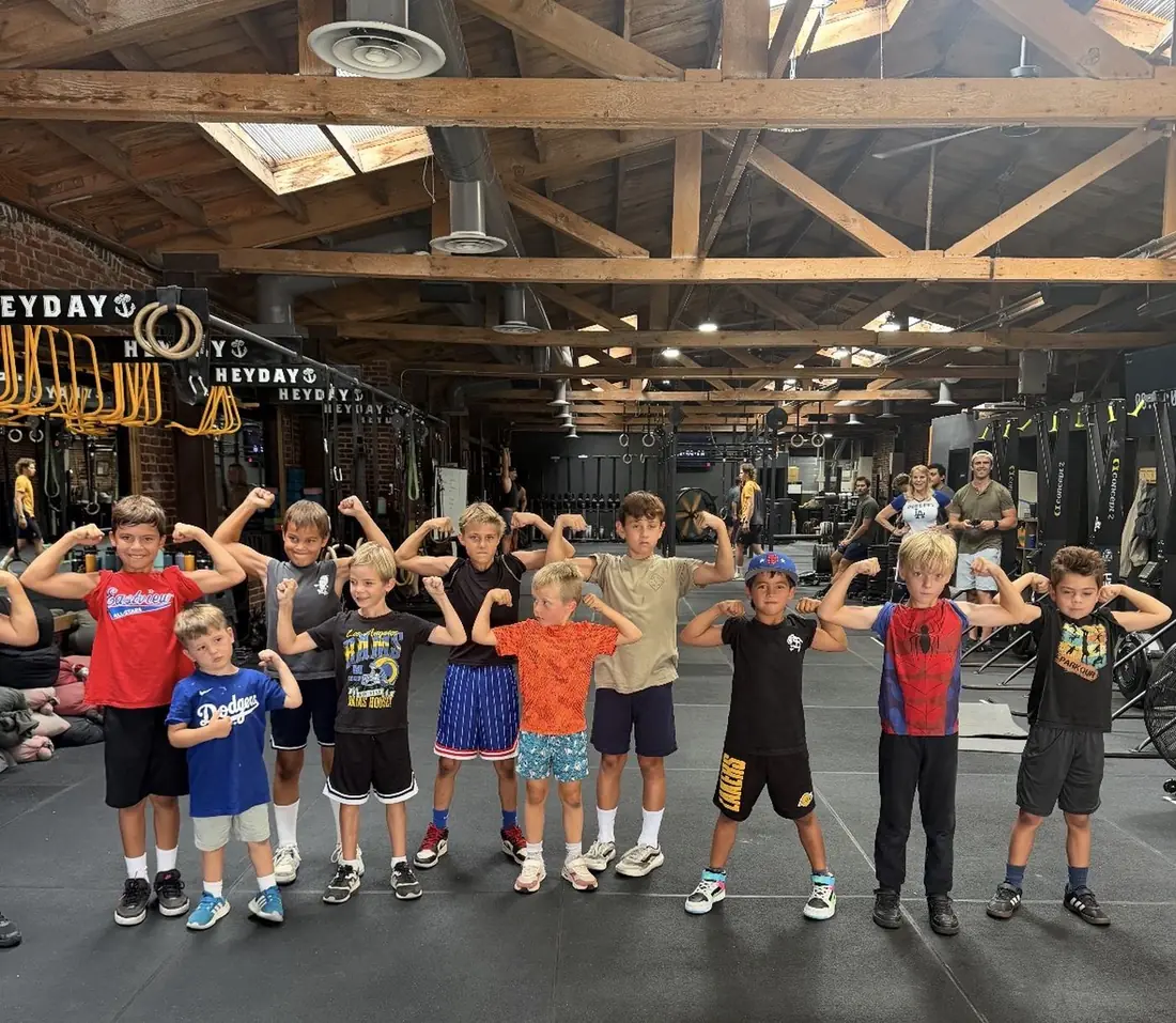 A HeyKids group flexing together at the end of class in the Heyday Elite Fitness gym in San Pedro